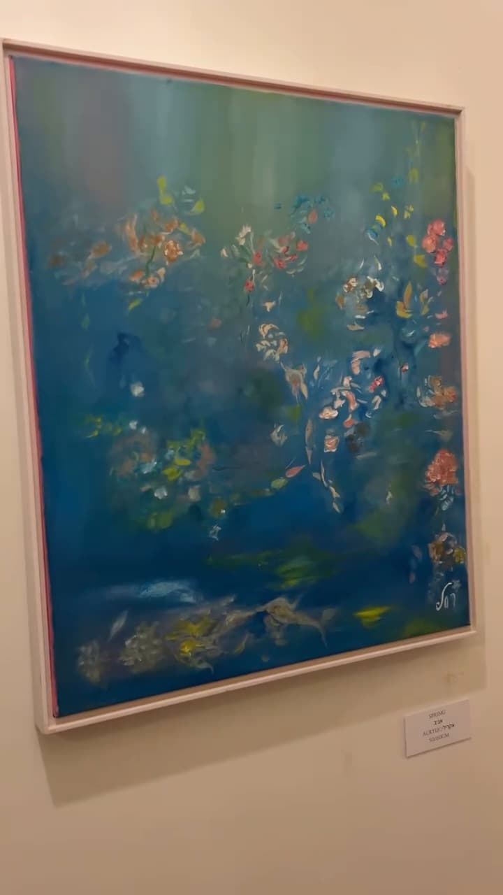 Spring, blue-green acrylic painting with small pink flowers, hung with its label at Échappées belles