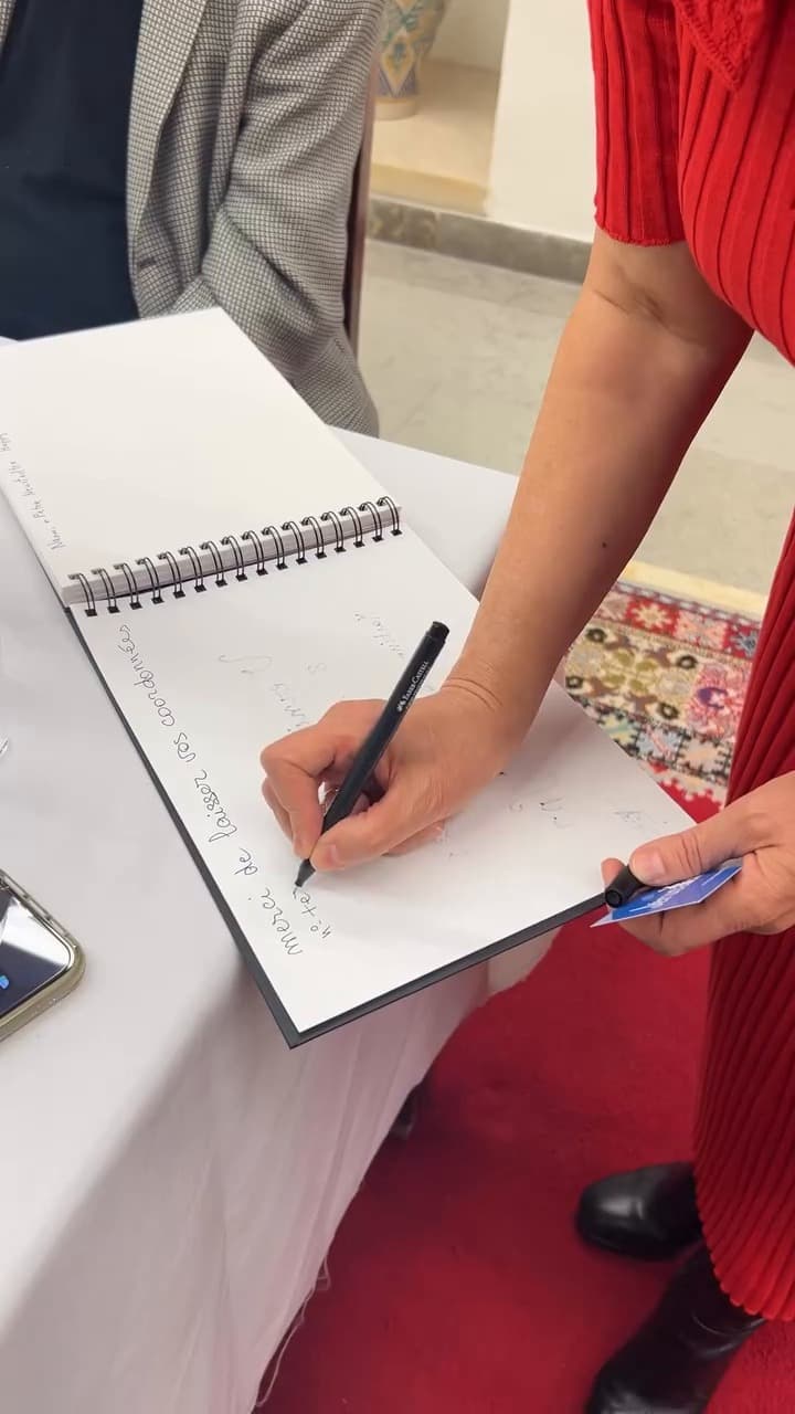 Hand writing in the guest book of the Échappées belles exhibition in Jerusalem