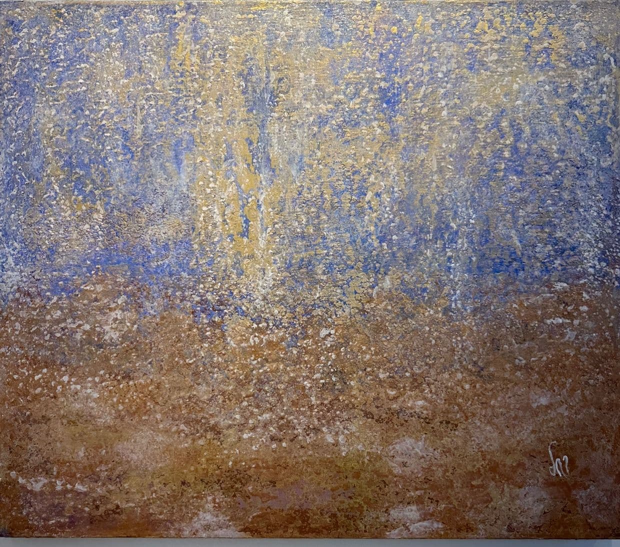 Abstract painting with white and gold flecks falling from an ultramarine blue upper half onto ochre and rust tones below